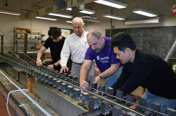 Students working in the lab building a bridge